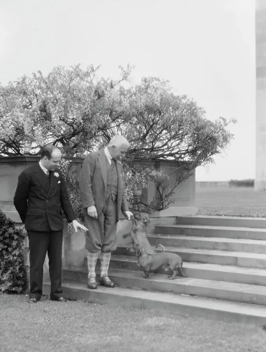 Framed Print : Kahn, Otto H. Mr. and unidentified man, with dog, standing outdoors, 1928 Creator: Arnold Genthe Framed Print : Kahn, Otto H. Mr. and unidentified man, with dog, standing outdoors, 1928 Creator: Arnold Genthe