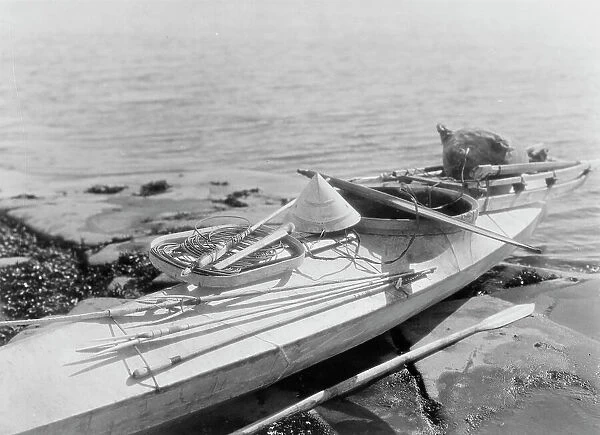 Kaiak with seal hunting equipment, Nunivak, c1929. Creator: Edward Sheriff Curtis