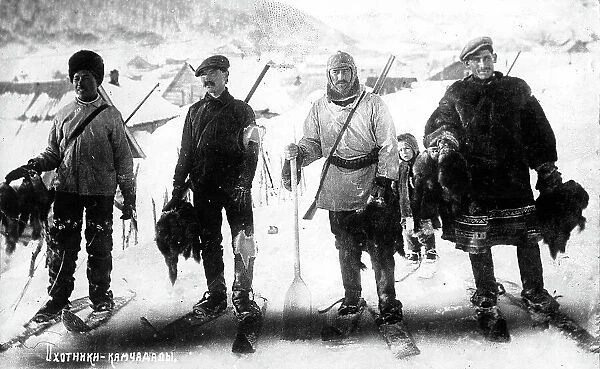 Kamchadal hunters against the backdrop of the city, with guns, furs, on skis, 1910-1929. Creator: Ivan Emelianovich Larin