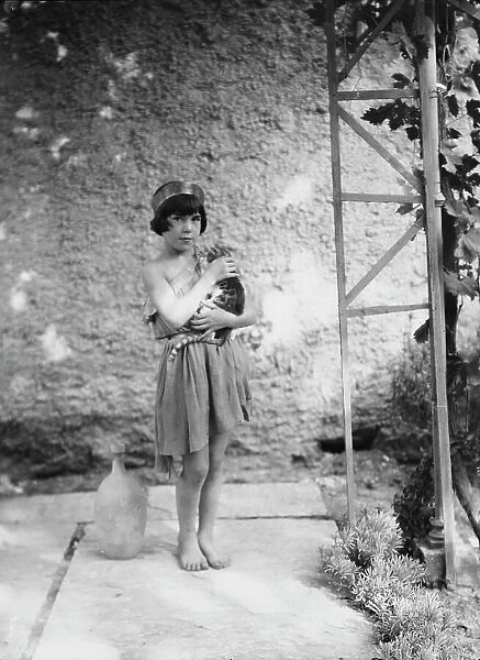 Kanellos child in dance costume holding a cat, 1929 Creator: Arnold Genthe