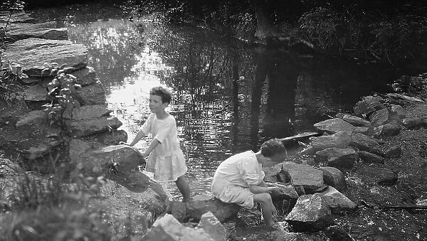 Kennerley, Richard and Morley, playing by a pond, 1912 or 1913. Creator: Arnold Genthe