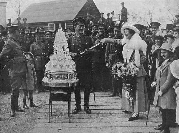 A khaki wedding: Cutting the wedding cake with the bridegrooms sword, 1915