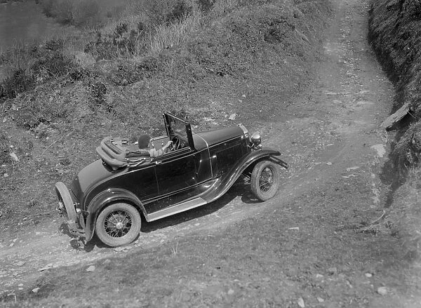 Kitty Brunell driving a 1930 2-seater Ford Model A, 1931. Artist: Bill Brunell