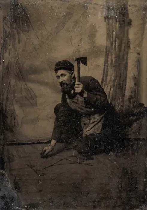 Framed Print : [Kneeling Carpenter Holding a Nail and Raised Hammer], 1870s-80s. Creator: Unknown
