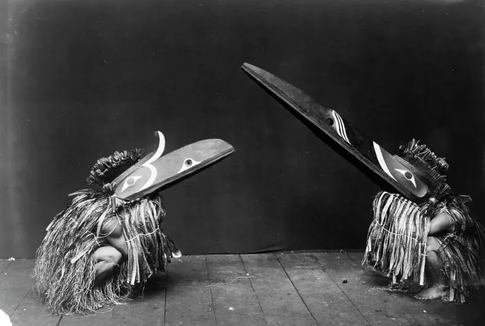 Framed Print : Kotsuis and Hohhug-Nakoaktok, wearing ceremonial dress, with long beaks, on their haunches... c1914 Creator: Edward Sheriff Curtis Framed Print : Kotsuis and Hohhug-Nakoaktok, wearing ceremonial dress, with long beaks, on their haunches... c1914 Creator: Edward Sheriff Curtis