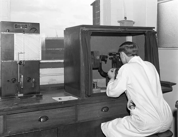 A lab tachnician with a Reichter Microscope at a steelworks, Sheffield, South Yorkshire, 1962