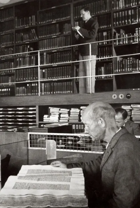 Framed Print : A labourer reads a book in a library, Germany, 1936 Framed Print : A labourer reads a book in a library, Germany, 1936