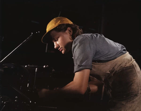 A lathe operator machining parts for...Consolidated Aircraft Corp. plant, Fort Worth, Texas, 1942. Creator: Howard Hollem