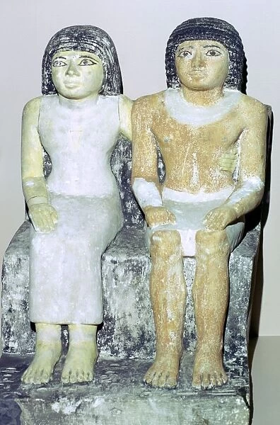 Limestone Egyptian statue of a man and his wife