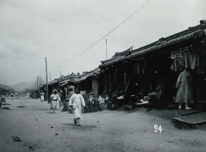 Framed Print : A line of shops beside a dusty street, with telegraph poles overhead, in Korea, c1900. Creator: Unknown Framed Print : A line of shops beside a dusty street, with telegraph poles overhead, in Korea, c1900. Creator: Unknown