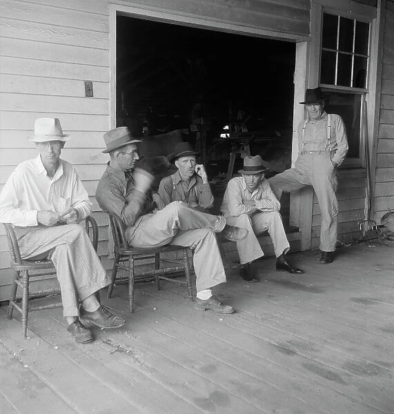 Livery stable gang talking politics...country of Senator 'Cotton Ed' Smith, South Carolina, 1938. Creator: Dorothea Lange. Livery stable gang talking politics...country of Senator 'Cotton Ed' Smith, South Carolina, 1938