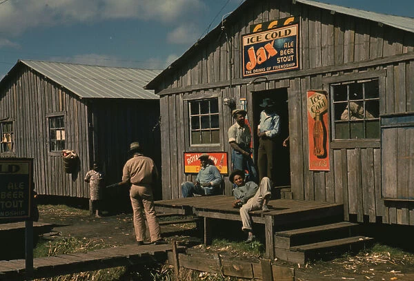 Living quarters and 'juke joint'for migratory workers, a slack season;Belle Glade, Fla. 1941. Creator: Marion Post Wolcott
