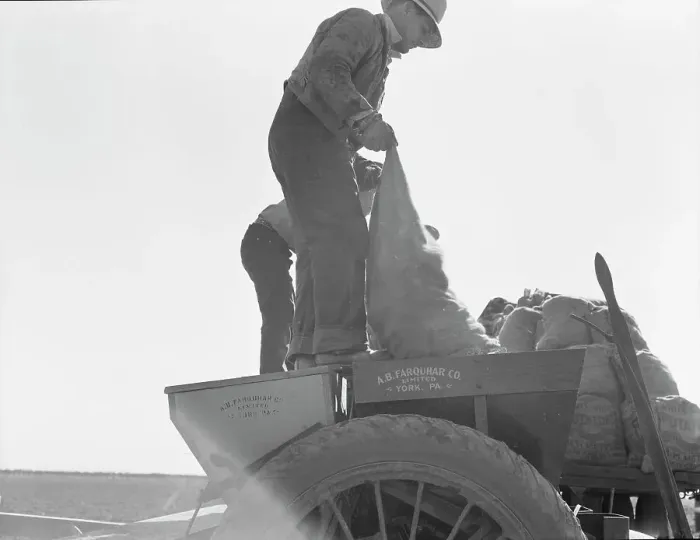 Framed Print : Loading bins of potato planter with fertilizer and seed... Kern County, California, 1939. Creator: Dorothea Lange