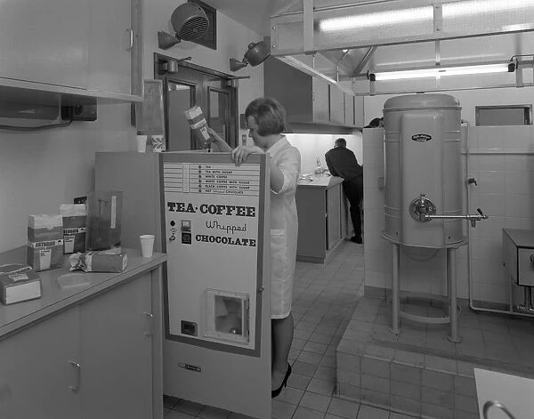 Loading a drinks vending machine at an experimental kitchen in Sheffield, South Yorkshire, 1966