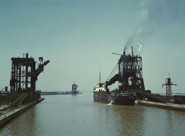 Loading a freighter with coal at one of the three coal docks owned by the... Sandusky, Ohio, 1943. Creator: Jack Delano
