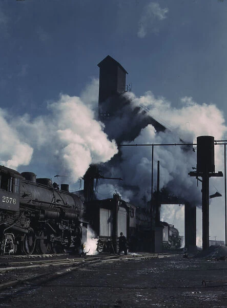 Locomotives over the ash pit at the roundhouse and coaling station... Chicago, Ill. 1942. Creator: Jack Delano