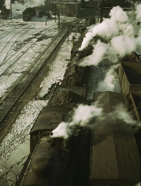 Locomotives lined up for coal, sand and water at the coaling station in the 40... Chicago, 1942. Creator: Jack Delano