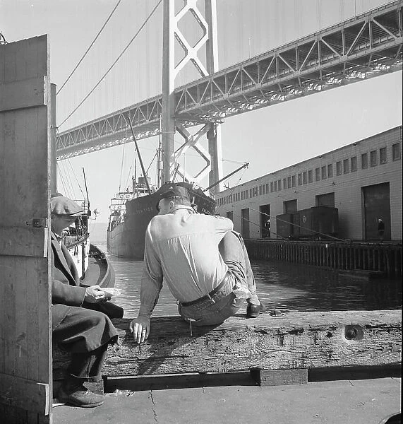 Longshoremen's lunch hour, San Francisco waterfront, California, 1937. Creator: Dorothea Lange