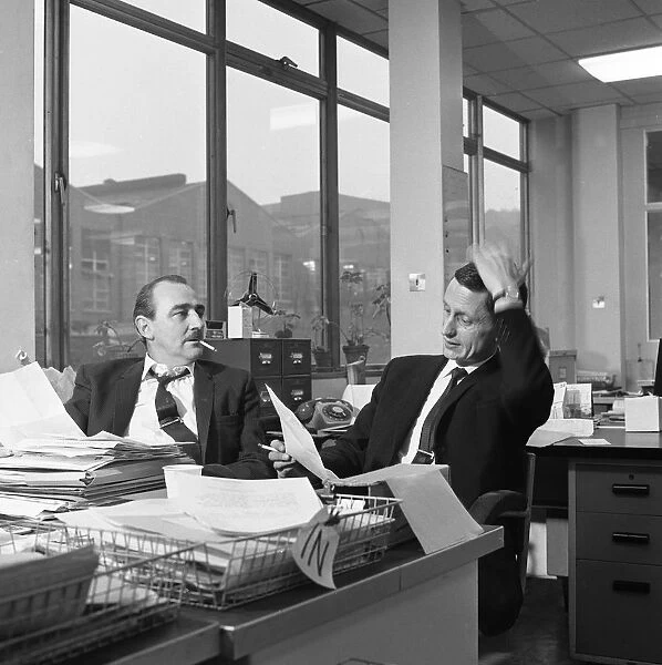 Lost order? two salesmen try to sort out the orders over a cigarette, 1967. Artist