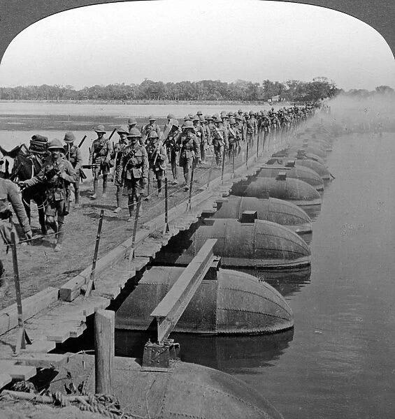 Machine gun section and infantry crossing a pontoon bridge, World War I, 1914-1918. Artist: Realistic Travels Publishers