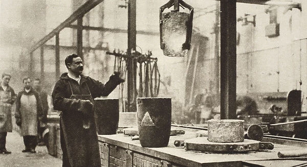 Making money; pots of liquid metal being handled in the melting room, 20th century