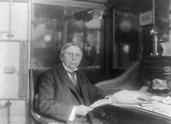 Man (banker?) seated at desk at American Security and Trust Co. Washington, D.C. c1890 - c1950. Creator: Frances Benjamin Johnston