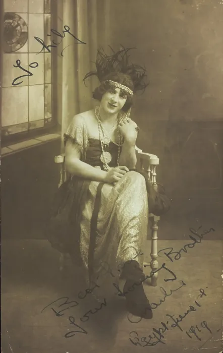 Framed Print : A man in drag (Charlie) sits face-on, wearing detailed costume, with a window painted... 1919. Creator: Unknown Framed Print : A man in drag (Charlie) sits face-on, wearing detailed costume, with a window painted... 1919. Creator: Unknown