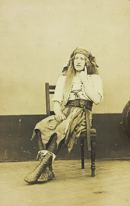 Framed Print : A man in drag sits pensively on a chair, on the deck of a ship, (between 1910 and 1919?). Creator: Unknown Framed Print : A man in drag sits pensively on a chair, on the deck of a ship, (between 1910 and 1919?). Creator: Unknown