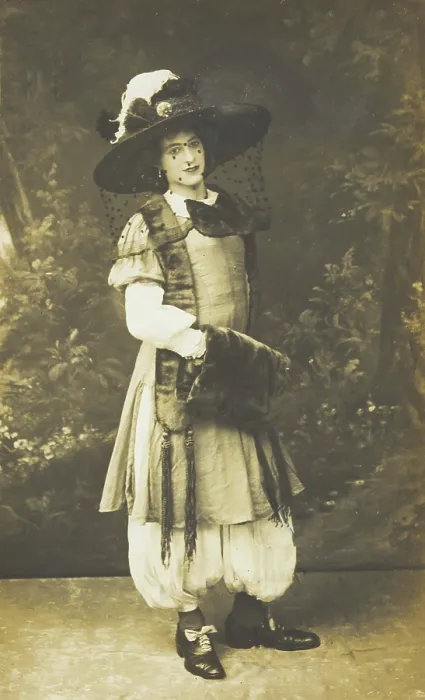 Framed Print : A man in drag wearing a very large hat with a veil, stands in front of a painted... 1911. Creator: Unknown Framed Print : A man in drag wearing a very large hat with a veil, stands in front of a painted... 1911. Creator: Unknown