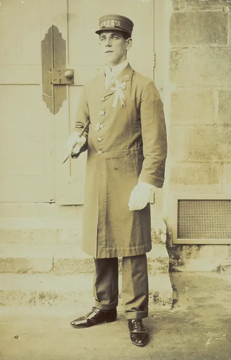 Framed Print : A man dressed wearing a long coat and a hat bearing the word 'Cook'...(1910-1919?). Creator: Unknown Framed Print : A man dressed wearing a long coat and a hat bearing the word 'Cook'...(1910-1919?). Creator: Unknown