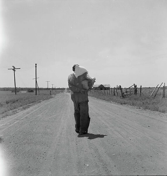 Man going home with relief, near Oil City, Carter County, Oklahoma, 1937. Creator: Dorothea Lange