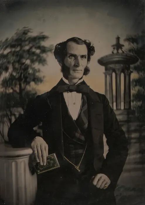 Framed Print : Man Holding Book, Standing Before a Painted Scenic Backdrop, 1850s-60s. Creator: Unknown Framed Print : Man Holding Book, Standing Before a Painted Scenic Backdrop, 1850s-60s. Creator: Unknown