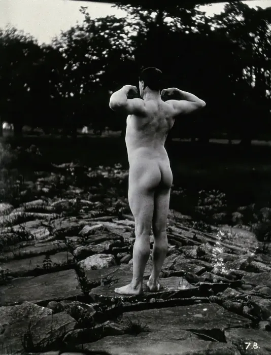 Framed Print : A man posing naked, with his back to the camera, standing on a rocky outcrop, c1900. Creator: Unknown Framed Print : A man posing naked, with his back to the camera, standing on a rocky outcrop, c1900. Creator: Unknown