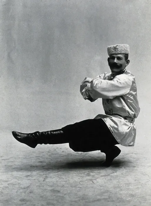Framed Print : A man, in a satin tunic and fur hat, dancing a 'Cossack' measure in a studio setting, 1899-1908. Creator: Unknown Framed Print : A man, in a satin tunic and fur hat, dancing a 'Cossack' measure in a studio setting, 1899-1908. Creator: Unknown