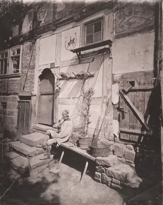 Framed Print : [Man Smoking Pipe Outside His Home on Village Street], 1880s. Creator: Unknown