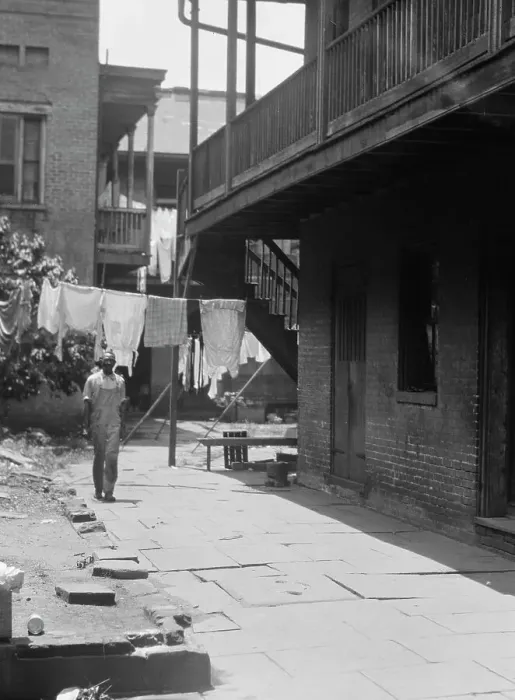 Framed Print : Man standing in a courtyard, New Orleans, between 1920 and 1926. Creator: Arnold Genthe Framed Print : Man standing in a courtyard, New Orleans, between 1920 and 1926. Creator: Arnold Genthe