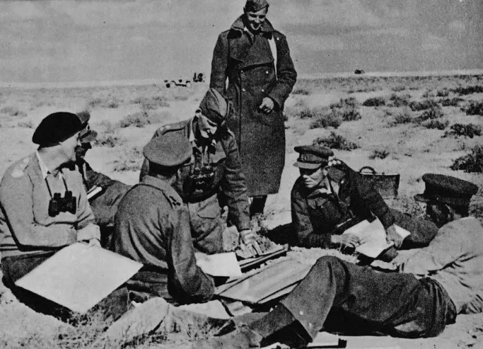 Framed Print : Maps and plans are spread on the sand, 1942 (1944) Framed Print : Maps and plans are spread on the sand, 1942 (1944)