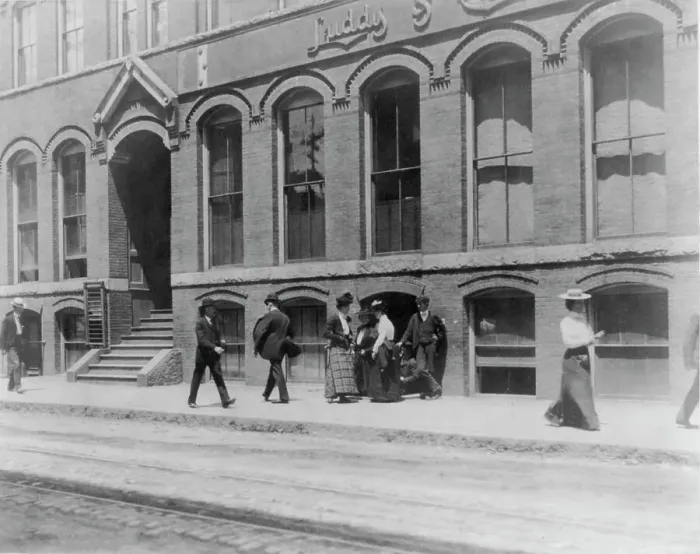 Framed Print : Massachusetts. Lynn. shoe factories, 1895?: sidewalk scene outside Luddy Co. (1895?). Creator: Frances Benjamin Johnston Framed Print : Massachusetts. Lynn. shoe factories, 1895?: sidewalk scene outside Luddy Co. (1895?). Creator: Frances Benjamin Johnston