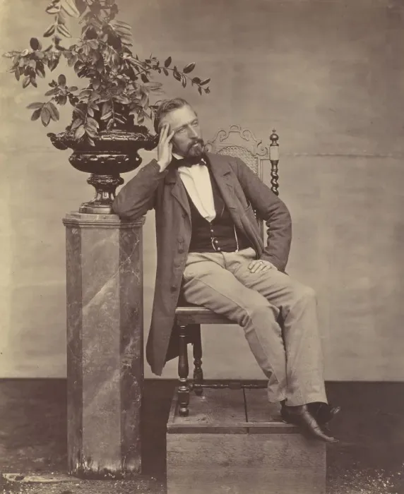 Framed Print : [Mathias Housermann seated with elbow on pedestal holding a vase of flowers]