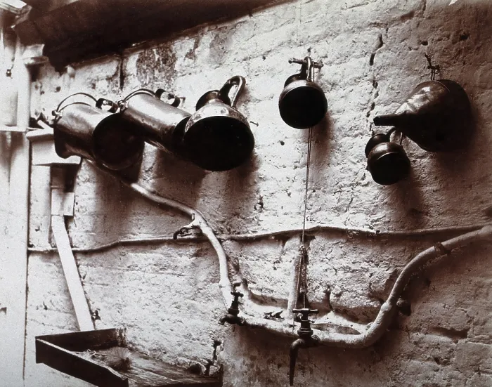 Framed Print : Measuring jugs and a funnel hung on a wall in the Red Cross pharmacy in London, c1890s. Creator: Unknown Framed Print : Measuring jugs and a funnel hung on a wall in the Red Cross pharmacy in London, c1890s. Creator: Unknown