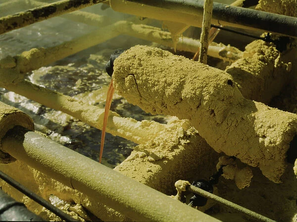 Melted sulphur from the wells pouring into relay... Freeport Sulphur Co, Hoskins Mound, Texas, 1943 Creator: John Vachon