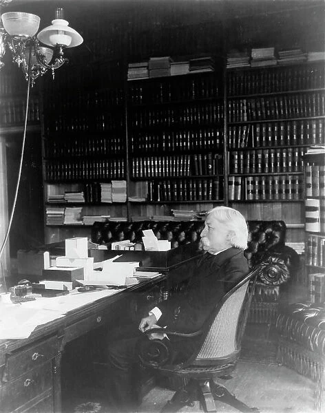 Melville Weston Fuller, full-length portrait, seated at desk, facing left, c1899. Creator: Frances Benjamin Johnston
