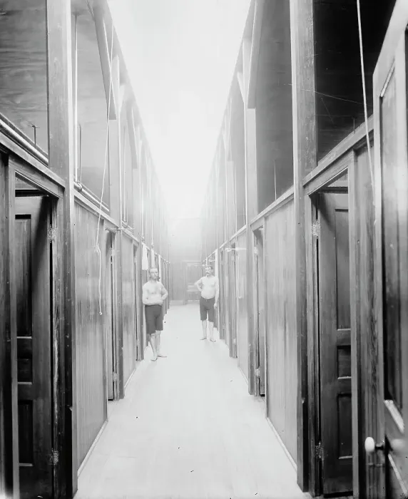 Framed Print : Two men in corridor, probably the Ypsilanti mineral bath house, Ypsilanti, Michigan, c1900-1910. Creator: Unknown Framed Print : Two men in corridor, probably the Ypsilanti mineral bath house, Ypsilanti, Michigan, c1900-1910. Creator: Unknown