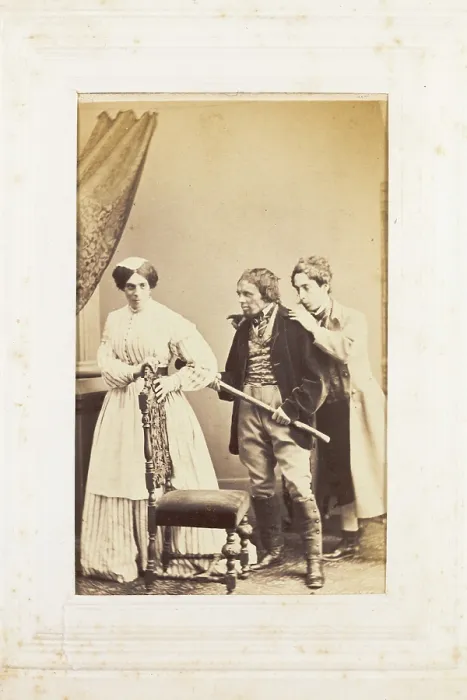 Framed Print : Three men, one in drag, acting out a scene, [between 1890 and 1899?]. Creator: Unknown
