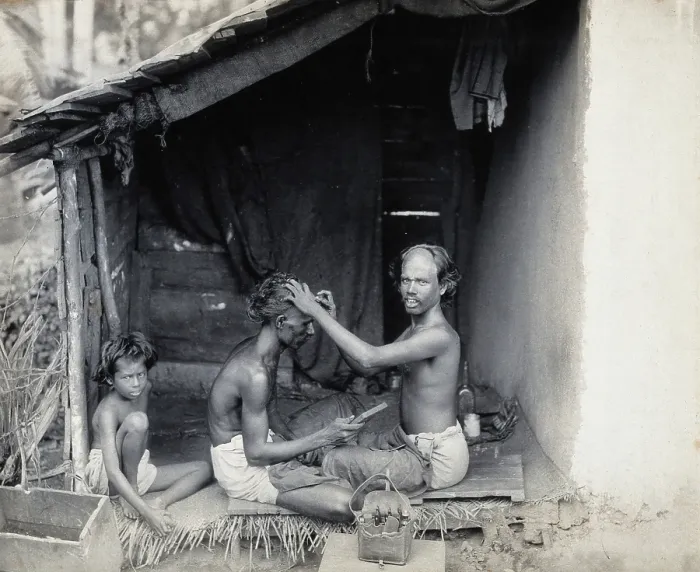 Framed Print : Two men sitting cross-legged; one is a barber shaving the front of the other's head, c1900 Framed Print : Two men sitting cross-legged; one is a barber shaving the front of the other's head, c1900