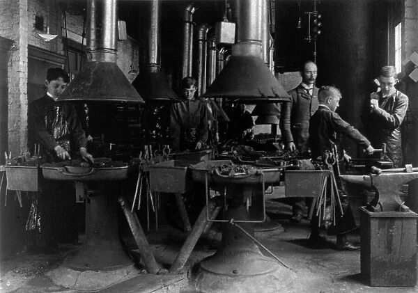 Metal shop (blacksmithing) class in a Washington, D.C. high school, (1899?). Creator: Frances Benjamin Johnston