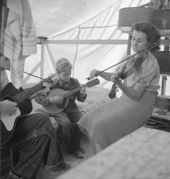 Framed Print : Migrant family from Arkansas playing hill-billy songs, FSA... migratory camp, Calipatria, CA, 1939. Creator: Dorothea Lange Framed Print : Migrant family from Arkansas playing hill-billy songs, FSA... migratory camp, Calipatria, CA, 1939. Creator: Dorothea Lange