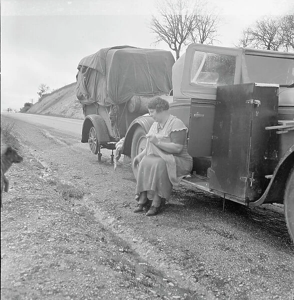 Migrant pea workers on the road, all their worldly possessions in car and trailer, California, 1936. Creator: Dorothea Lange
