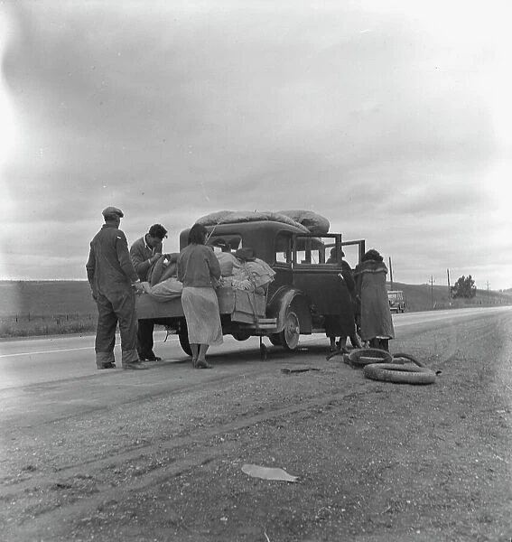 Migrants, family of Mexicans, on road with tire trouble, looking for work... CA, 1936. Creator: Dorothea Lange