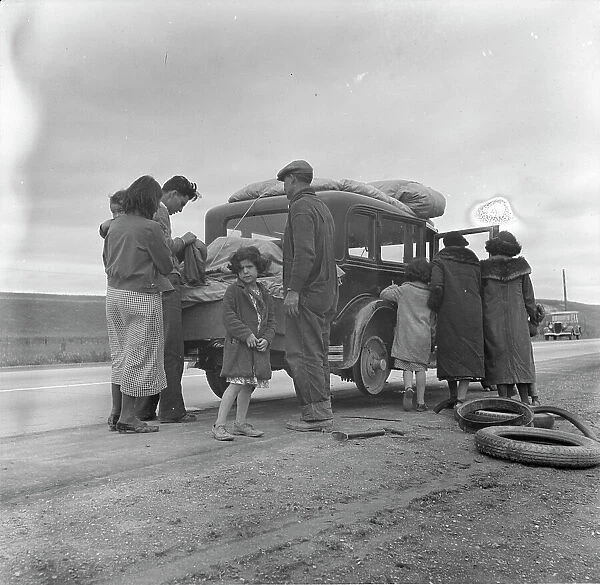 Migrants, family of Mexicans, on road with tire trouble, looking for work...California, 1936. Creator: Dorothea Lange